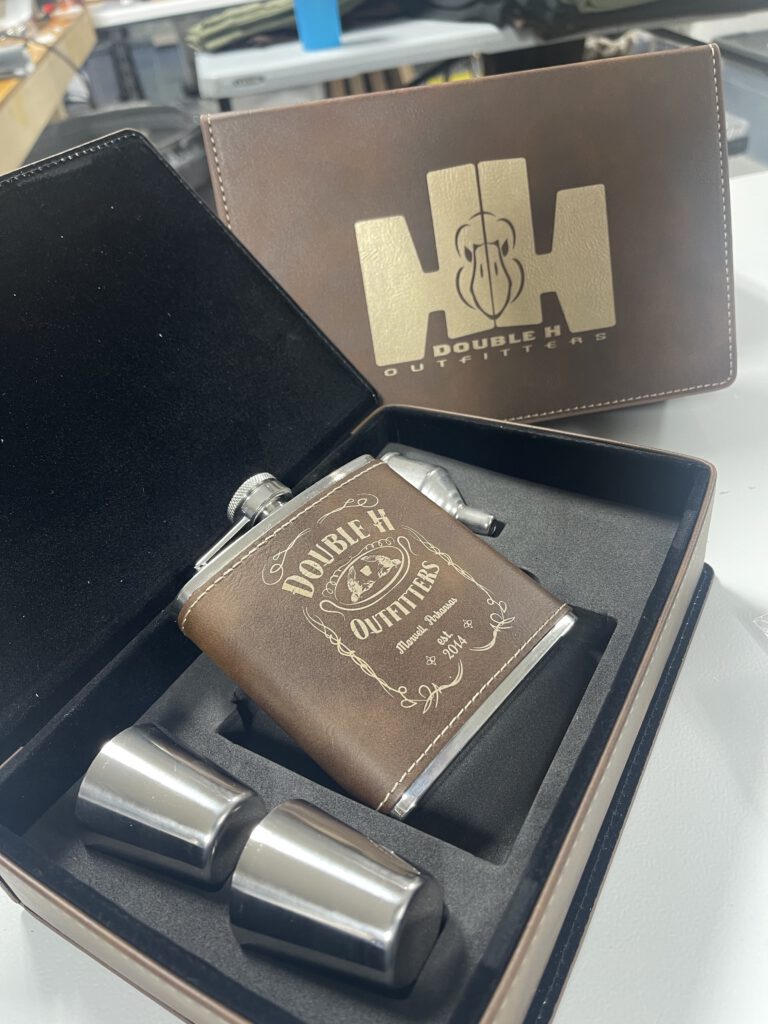 Leatherette flask gift set with two shot cups, the flask and the box lid engraved with Double H Outfitters designs