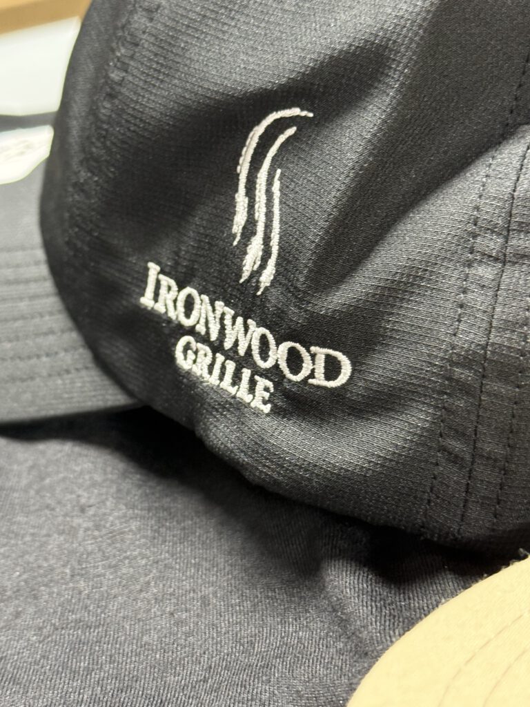 Black performance hat with the Ironwood Grille logo embroidered in white