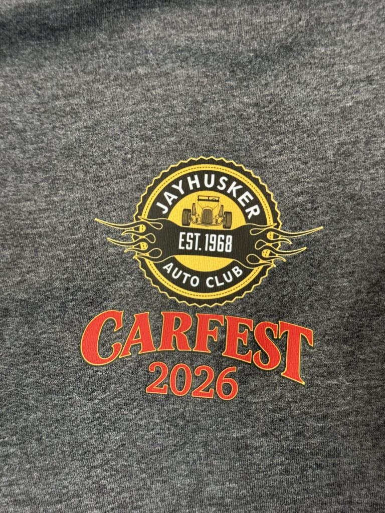 Dark gray shirt with the JayHusker Auto Club badge and Carfest 2026 on the chest