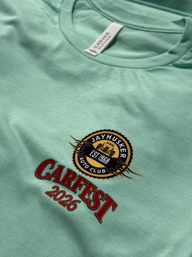 Mint shirt with the JayHusker Auto Club badge and Carfest 2026 on the chest