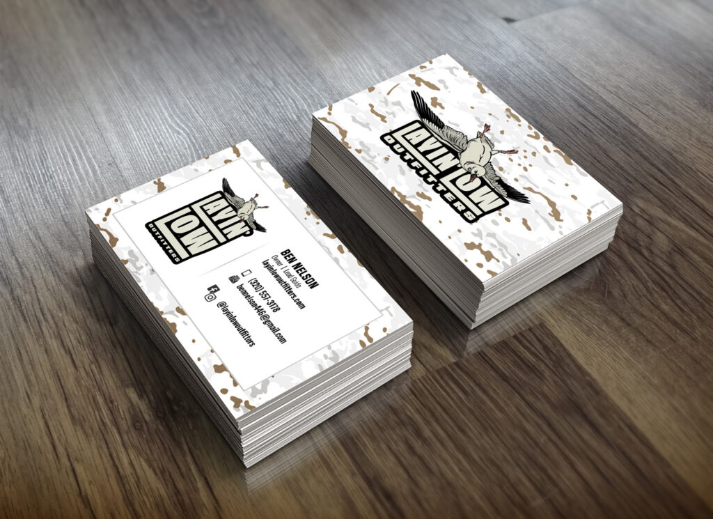 Mockup of Layin' Low Outfitters business cards, front and back, with a white camo border