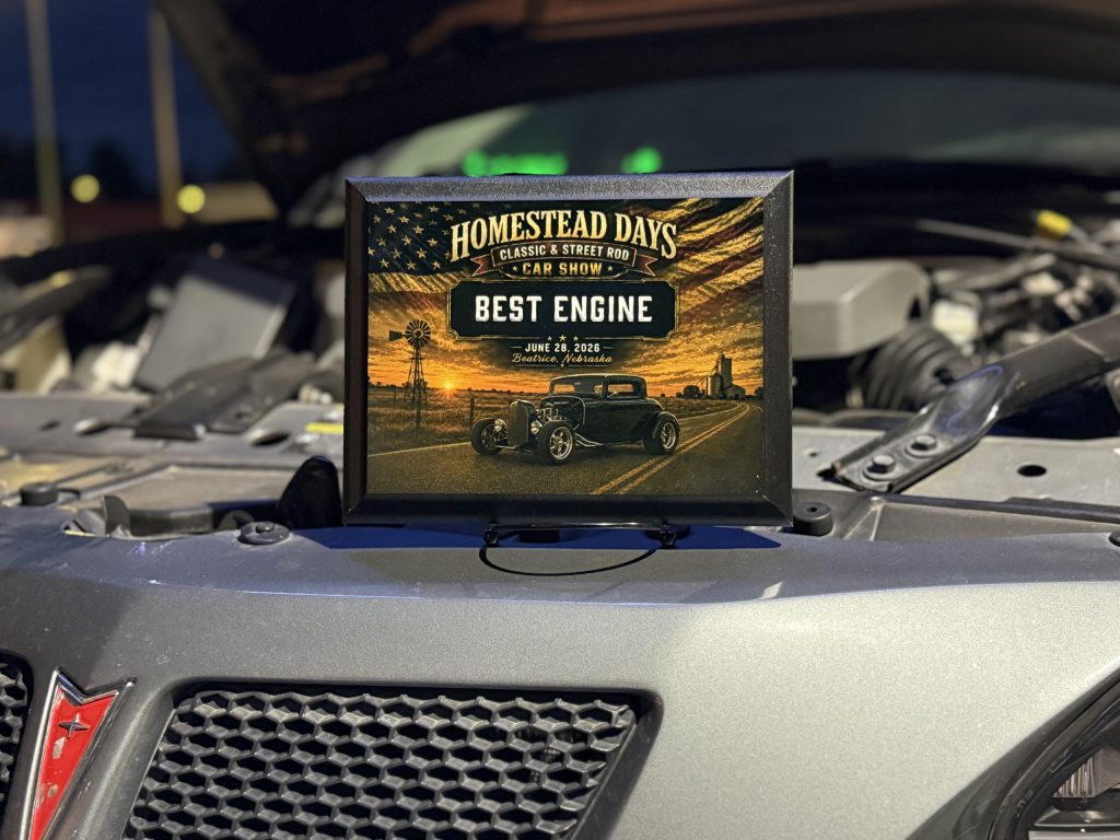 The Best Engine plaque displayed in a car's open engine bay